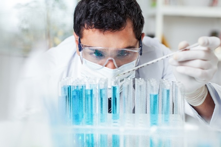 Scientist handling vials